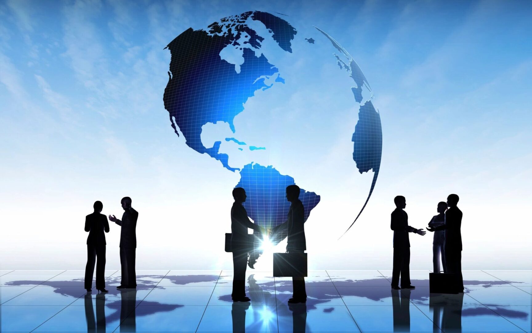 A group of people standing in front of an earth globe.